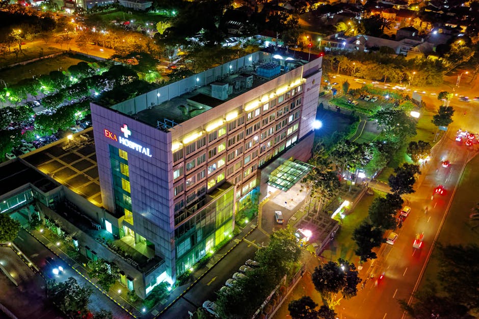 Stunning aerial view of Eka Hospital in Serpong, Indonesia, illuminated at night, capturing vibrant city lights and architecture.