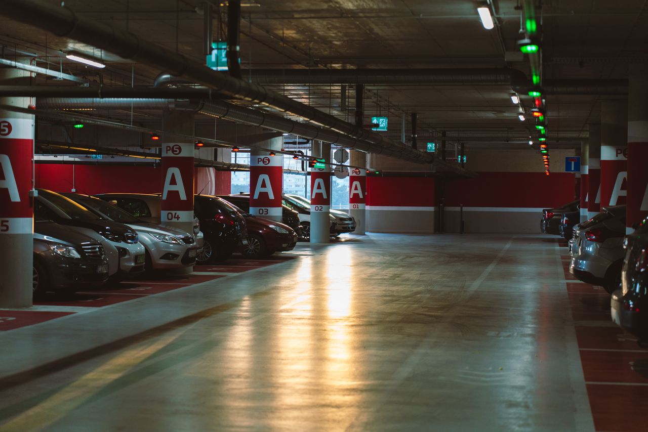 Explore a well-lit underground parking garage in Budapest, showcasing urban architecture and modern facilities.