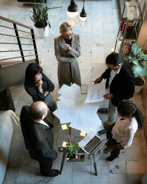 A team of professionals engage in a business meeting in a sleek, modern office setting.